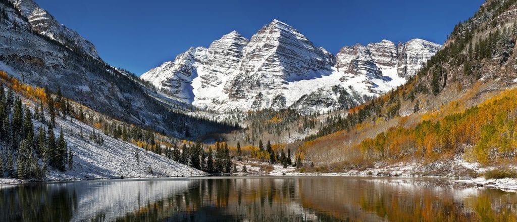 The snow covered Maroon Bells mountains in Colorado are stunningly beautiful.
