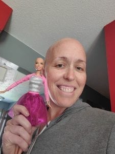 breast-cancer-thriver-kendra-brower-holds-a-barbie-doll