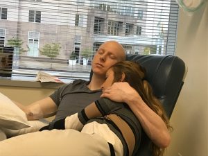 Matt-Ode-and-girlfriend-snuggle-during-a-chemo-infusion