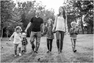 Joanna Dennstaedt, melanoma survivor and founder of Radiant Hope, walks with her family in a field of black and white