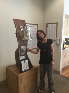 Joanna Dennstaedt, melanoma survivor and founder of Radiant Hope, rings the survivor bell
