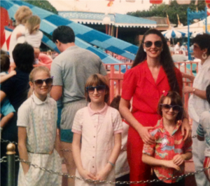 Lynn Eib, author and cancer survivor, poses in a photo from 1989 with her daughters, all of them are wearing sunglasses. 